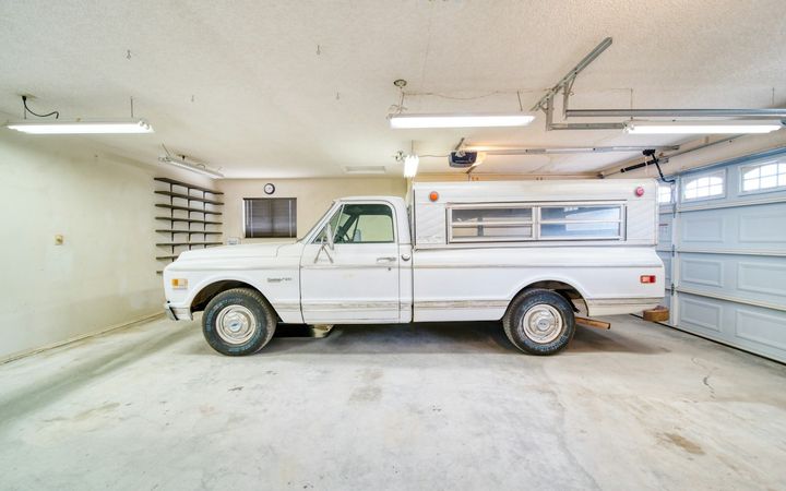 Pickup truck parked in a garage with a finished drywall ceiling