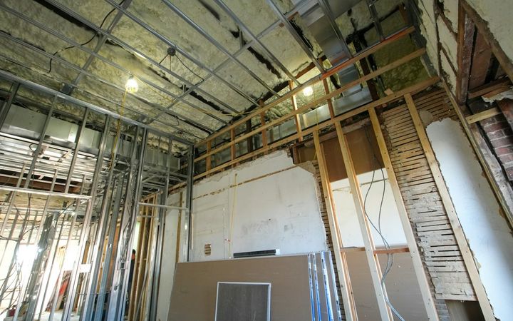 Interior framed with metal studs, with drywall sheets going up