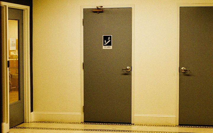 Commercial corridor with steel doors and an exit sign