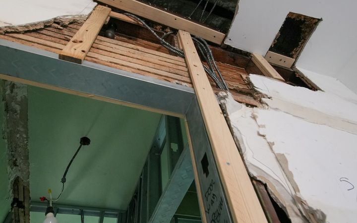 Damaged ceiling opened up to the wood framing and wiring